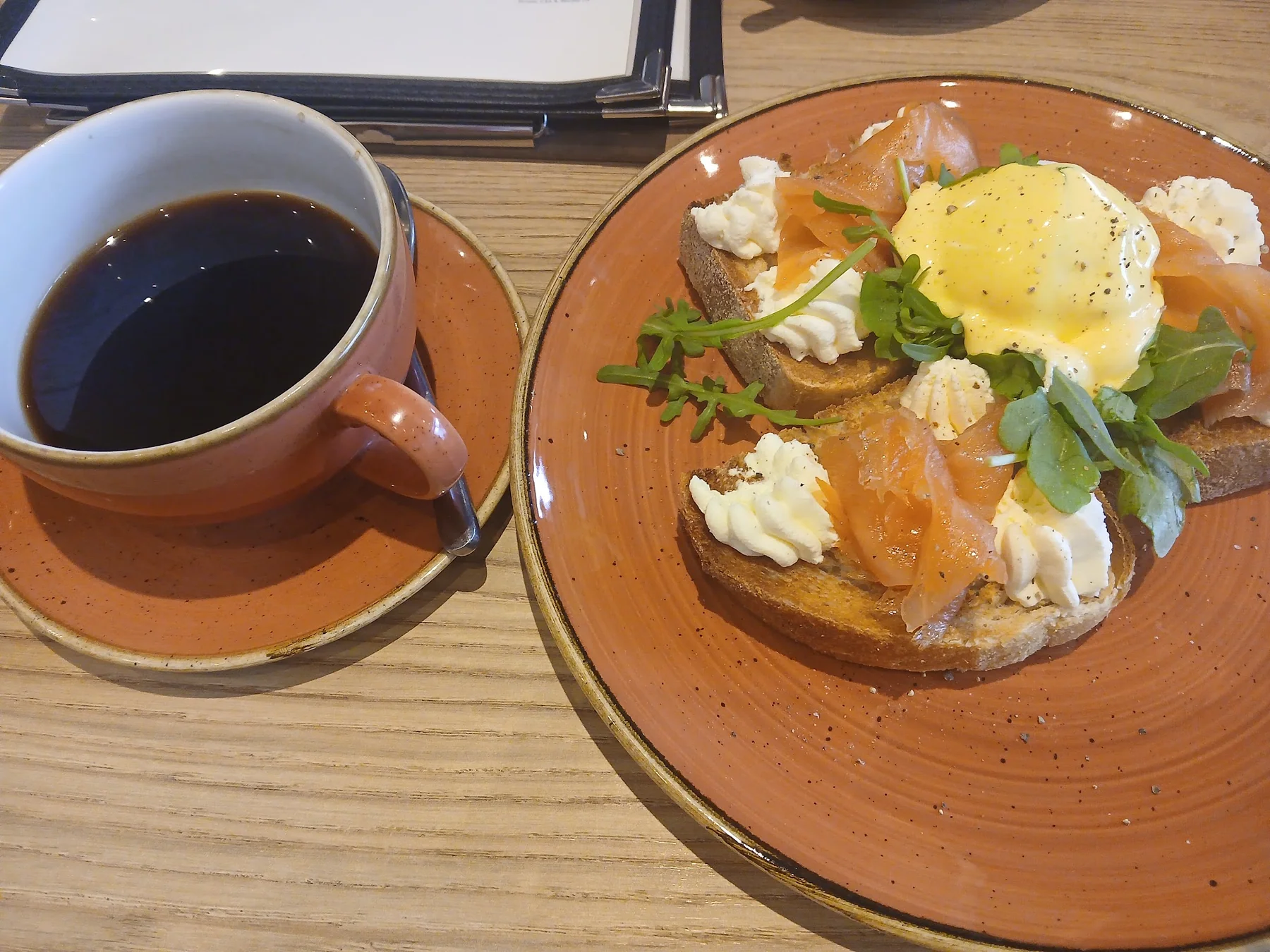 Coffee and a freshly plated breakfast at Crustiq