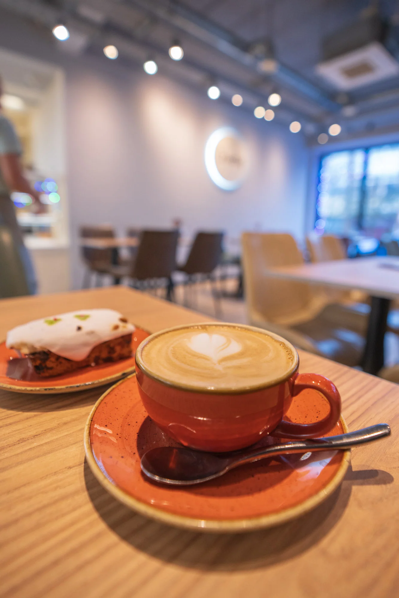 Coffee and cake with the Crustiq cafe seating in the background