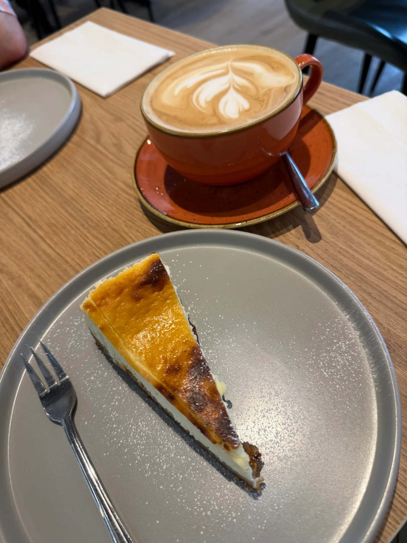 A slice of cake and a cup of coffee served at Crustiq